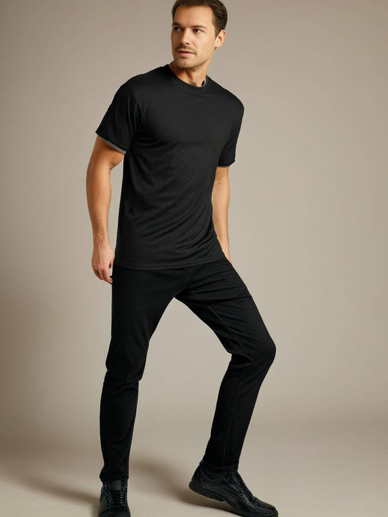 Man in a black crewneck t-shirt and black pants, showcasing stylish comfort and modern fit.