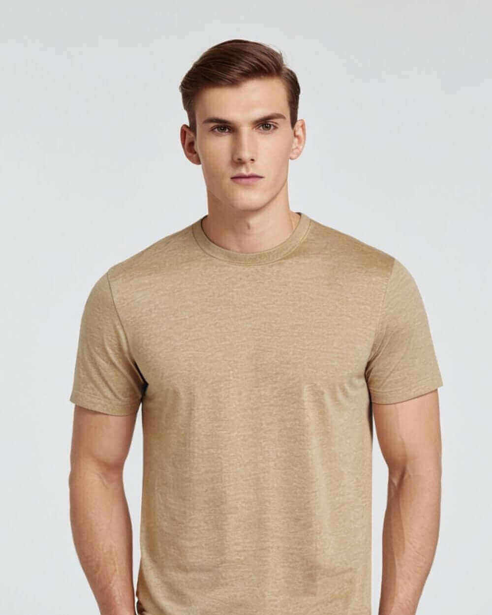 Male model wearing a beige crewneck t-shirt, highlighting its soft and durable fabric blend.