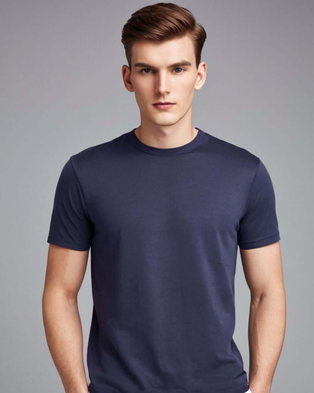 Model wearing a navy Monak Crewneck t-shirt showcasing softness and durability in a classic fit.